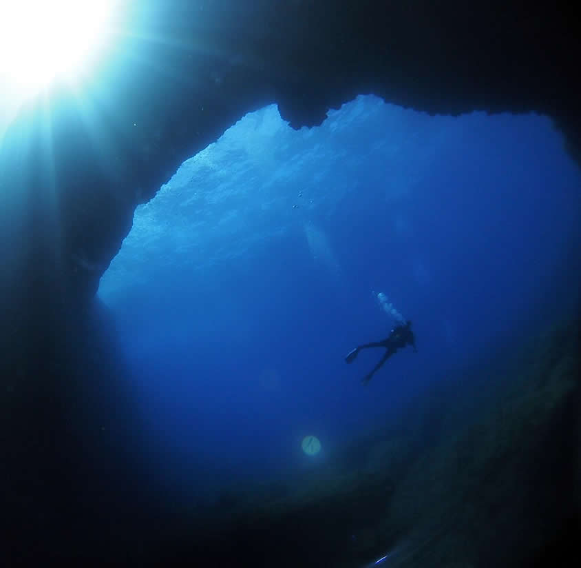 Diver underwater at the Blue Hole in Dwejra, Gozo